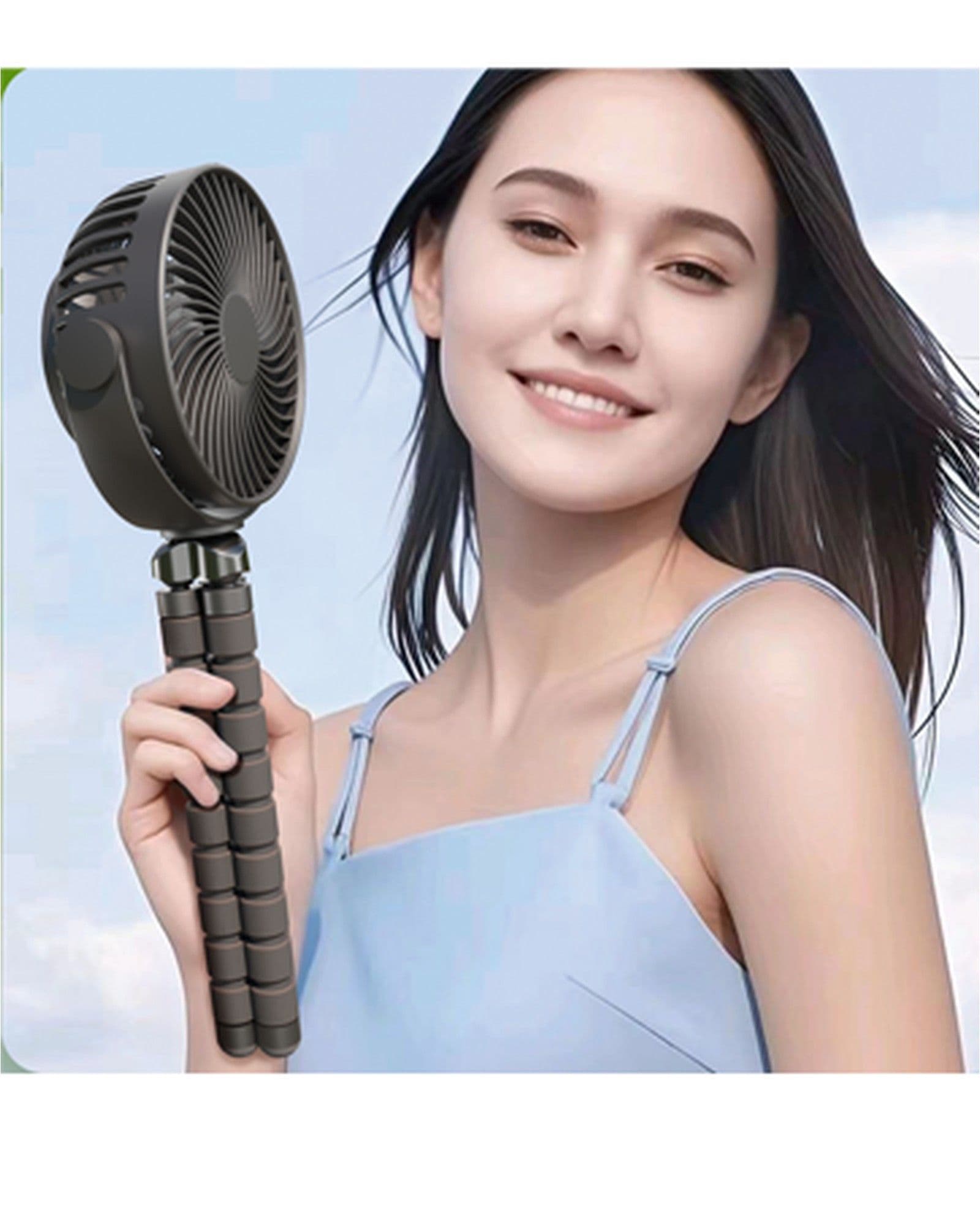 A woman smiling while holding an Airbro FFX-50 portable fan with a flexible tripod stand against a blue sky background.