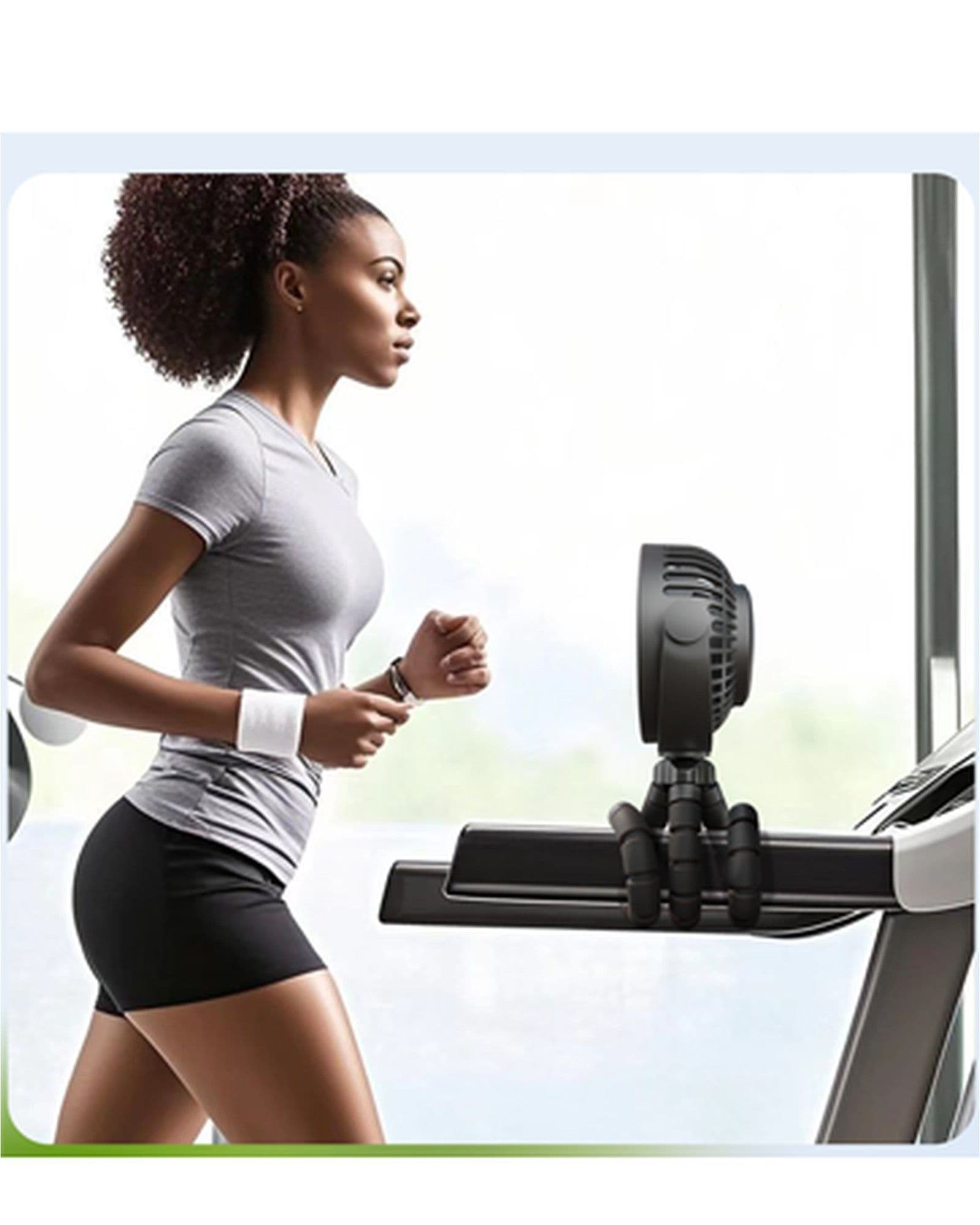 A woman running on a treadmill with an Airbro FFX-50 portable fan attached to the handle.