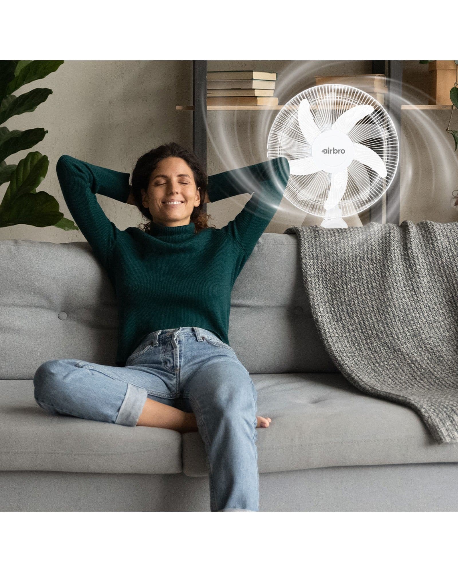 A woman relaxing on a sofa with an Airbro FSA-160 fan nearby, showing a visual effect of airflow.